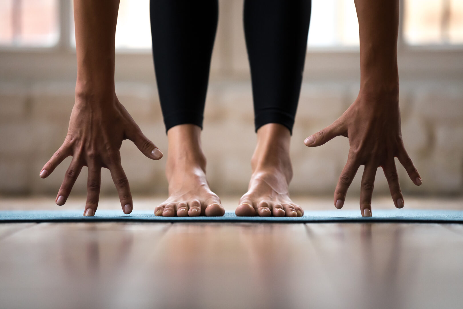 sporty active woman practicing yoga, doing bend exercise, close